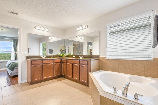 1416 Cabot Dr, Clermont, FL 34711 - full bathroom featuring double vanity, visible vents, a bath, and a sink