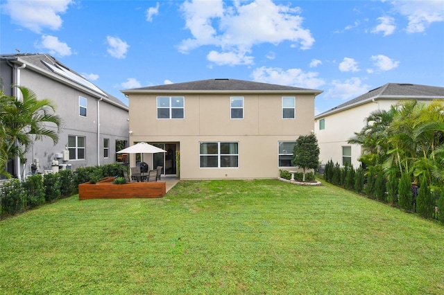 1416 Cabot Dr, Clermont, FL 34711 - back of house with stucco siding and a lawn