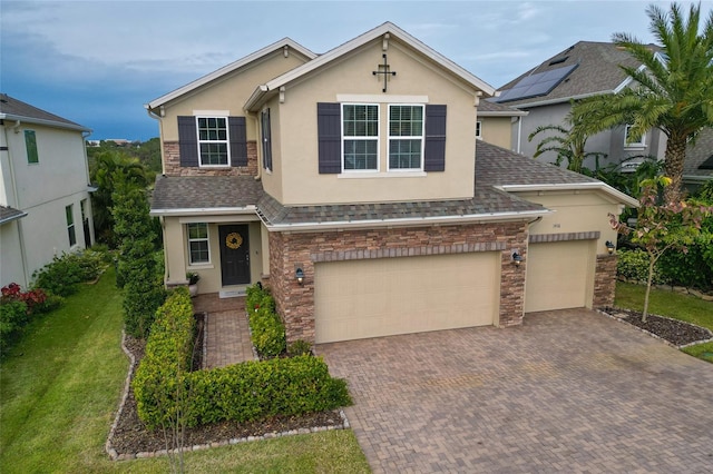 1416 Cabot Dr, Clermont, FL 34711 - view of front of property with stone siding, stucco siding, decorative driveway, and roof with shingles