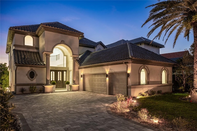 mediterranean / spanish-style home featuring a garage and french doors