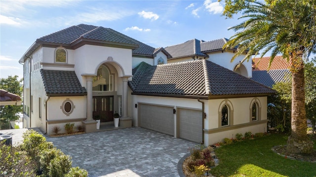 mediterranean / spanish house featuring a garage