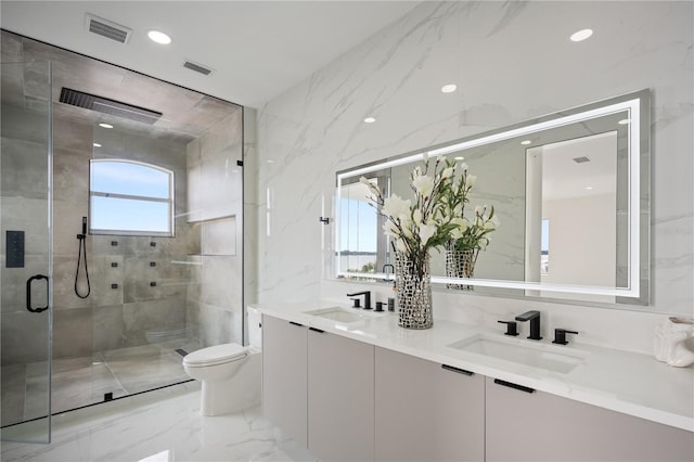 bathroom with vanity, a shower with door, and toilet