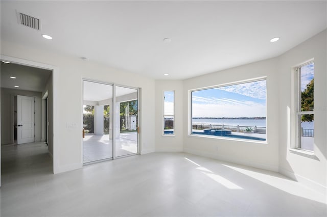 spare room featuring a water view