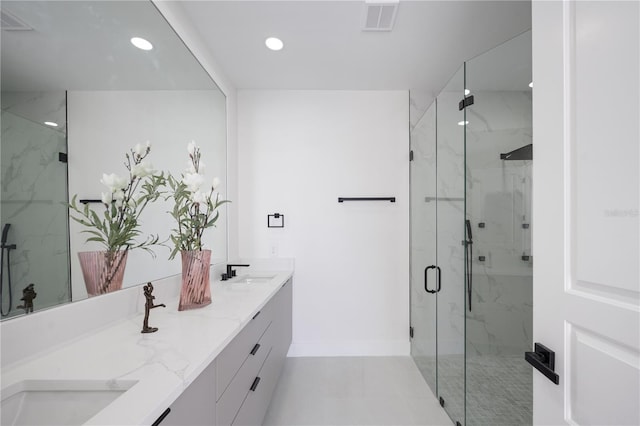 bathroom with vanity and a shower with door