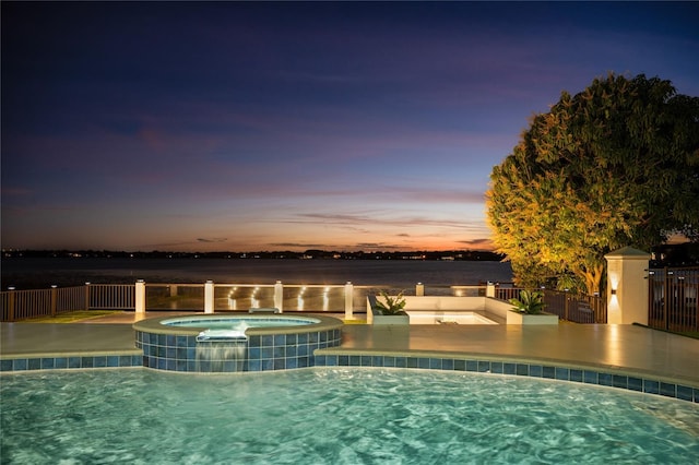 pool at dusk with central AC, a water view, and an in ground hot tub