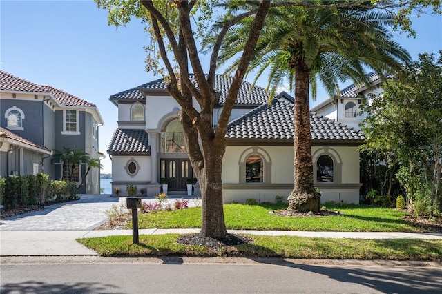 mediterranean / spanish-style house featuring a front yard