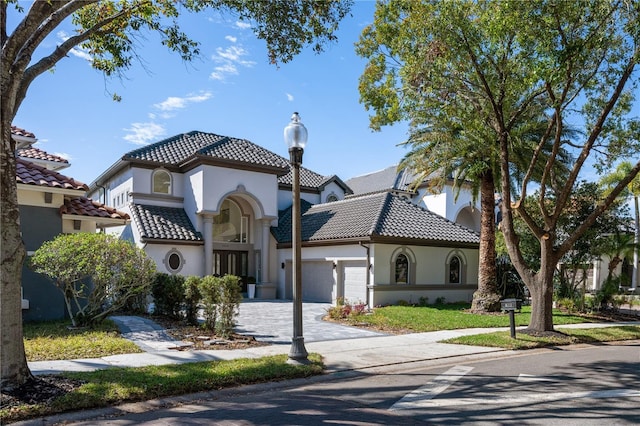 mediterranean / spanish home with a garage