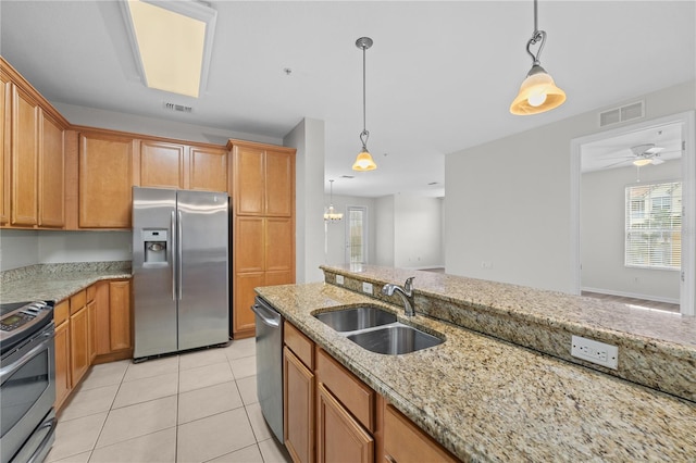 kitchen featuring appliances with stainless steel finishes, ceiling fan, decorative light fixtures, and sink