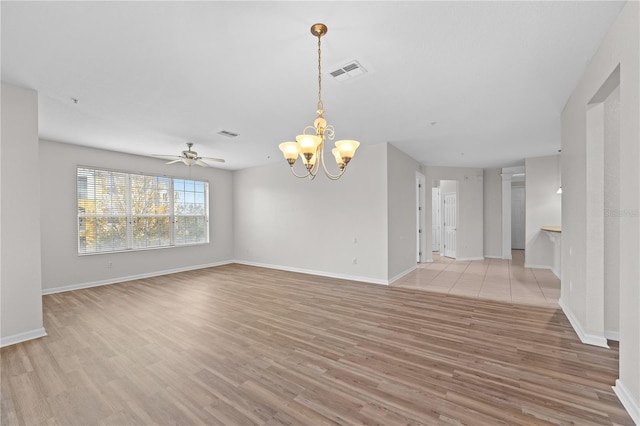 empty room with ceiling fan with notable chandelier and light wood-type flooring