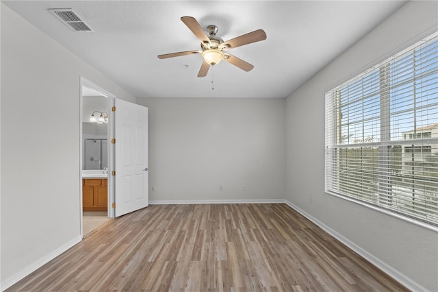 spare room with sink, ceiling fan, and light wood-type flooring