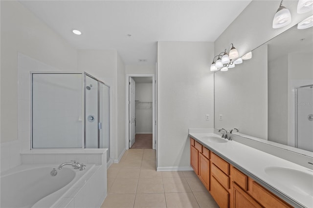 bathroom with tile patterned floors, independent shower and bath, and vanity