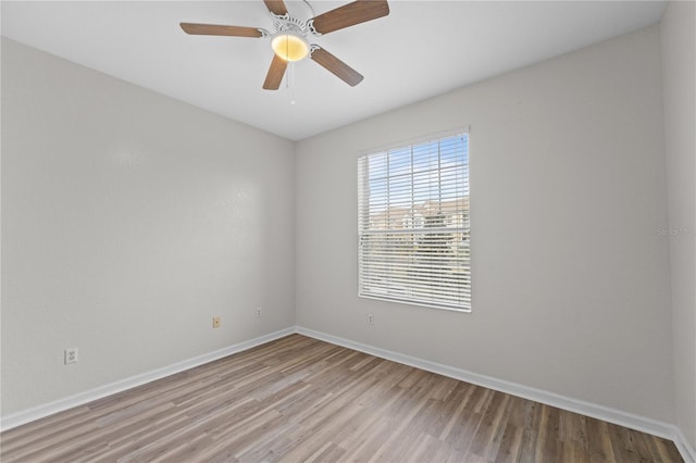 empty room featuring ceiling fan and light hardwood / wood-style flooring