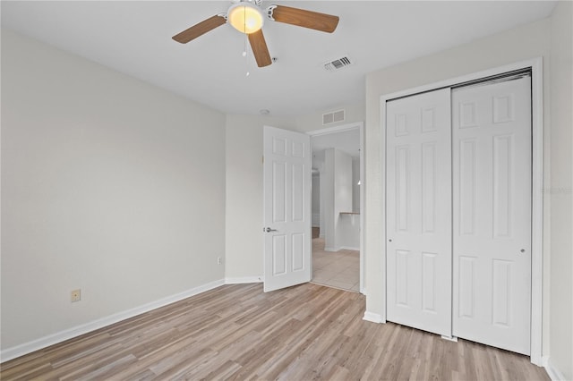 unfurnished bedroom featuring a closet, ceiling fan, and light hardwood / wood-style flooring