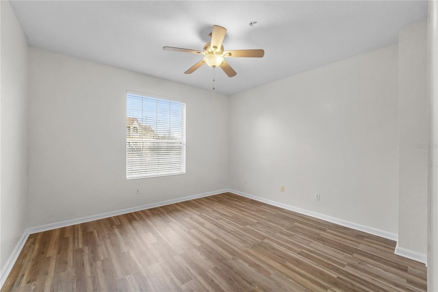 empty room featuring ceiling fan and hardwood / wood-style flooring