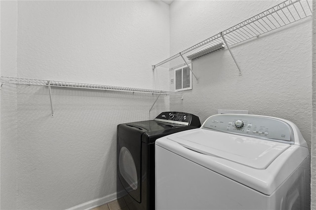 laundry room featuring washing machine and clothes dryer