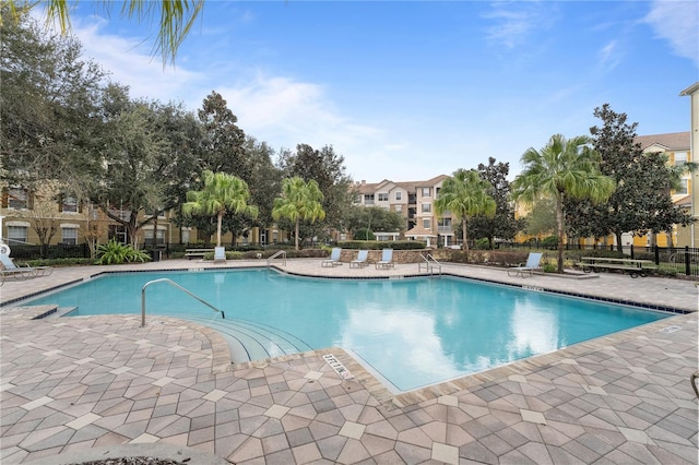 view of swimming pool featuring a patio area