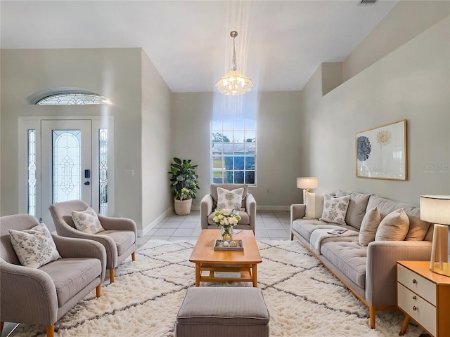 tiled living room with a notable chandelier