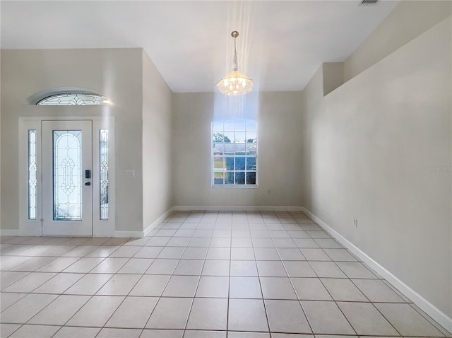 foyer featuring light tile patterned floors and a chandelier