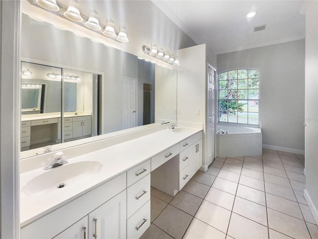 bathroom with tiled bath, vanity, and tile patterned flooring