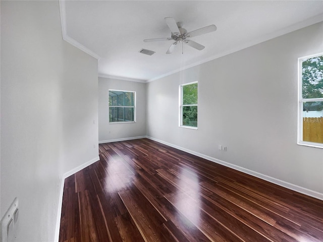 empty room with ceiling fan, dark hardwood / wood-style floors, and crown molding