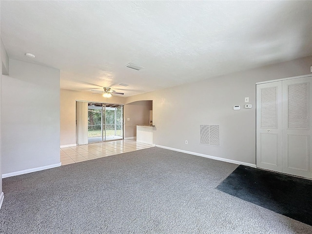 unfurnished living room with ceiling fan and light carpet