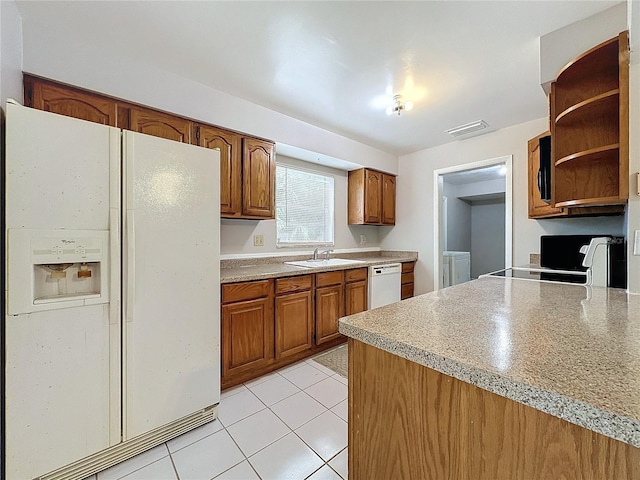 kitchen with light tile patterned floors, sink, and white appliances