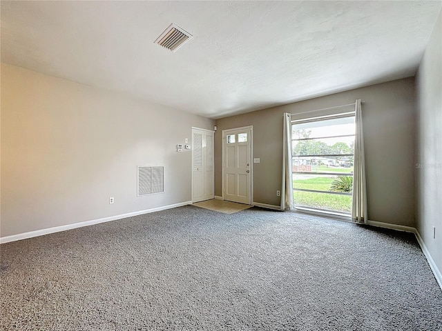 entrance foyer with carpet flooring