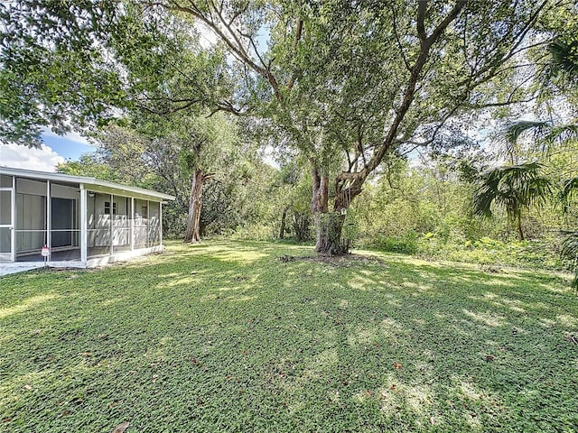 view of yard featuring a sunroom