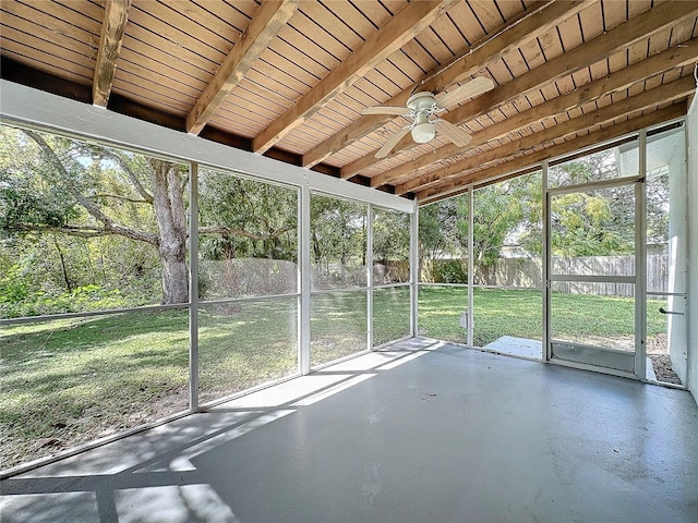 unfurnished sunroom featuring wooden ceiling, beam ceiling, and ceiling fan