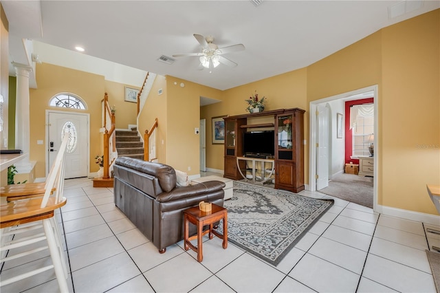 living room featuring ceiling fan, ornate columns, and light tile patterned flooring