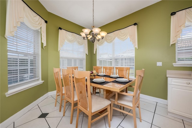 dining space featuring light tile patterned floors and a notable chandelier