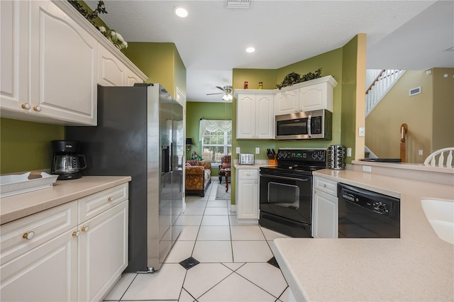 kitchen with black appliances, light tile patterned floors, ceiling fan, and white cabinetry