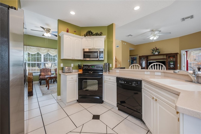 kitchen with ceiling fan, sink, white cabinets, and black appliances