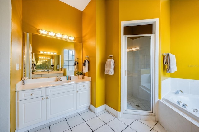 bathroom featuring vanity, tile patterned flooring, and plus walk in shower