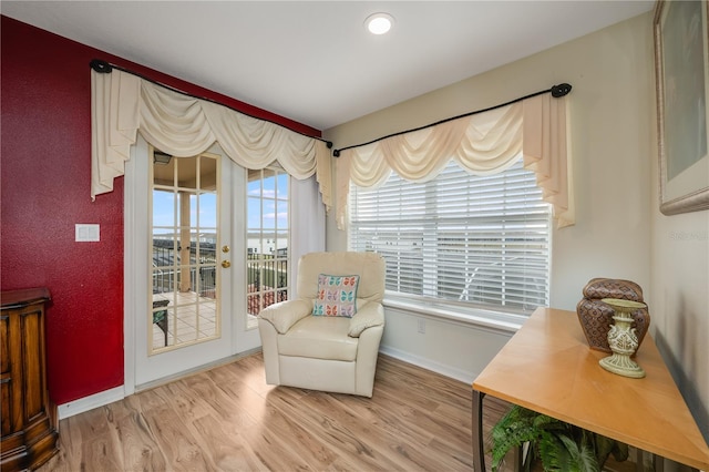 sitting room with wood-type flooring and french doors