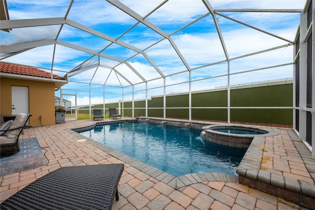 view of pool featuring an in ground hot tub, a lanai, pool water feature, and a patio