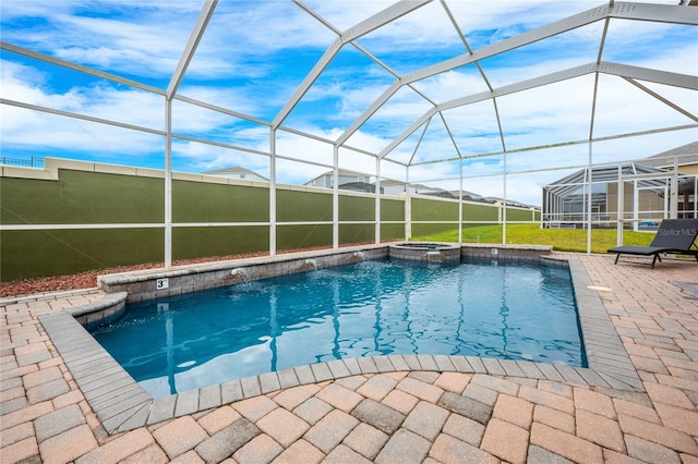 view of pool featuring glass enclosure, a patio area, and an in ground hot tub