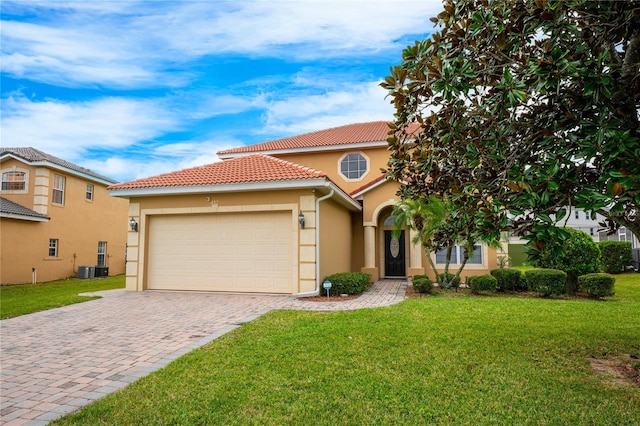 mediterranean / spanish house with a garage and a front lawn