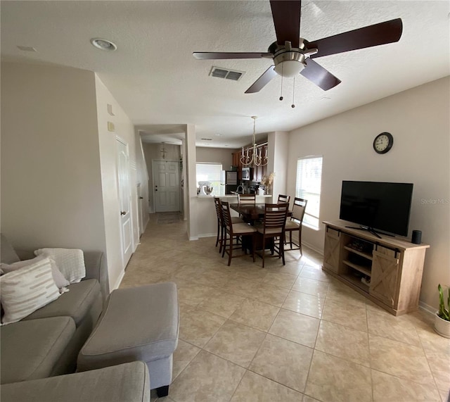 dining area with ceiling fan and light tile patterned flooring