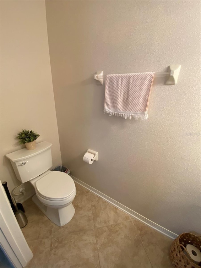 bathroom featuring toilet and tile patterned flooring