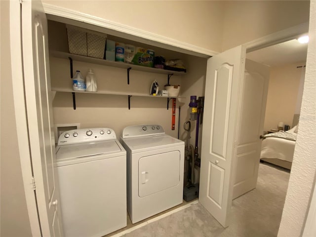 washroom featuring light carpet and separate washer and dryer