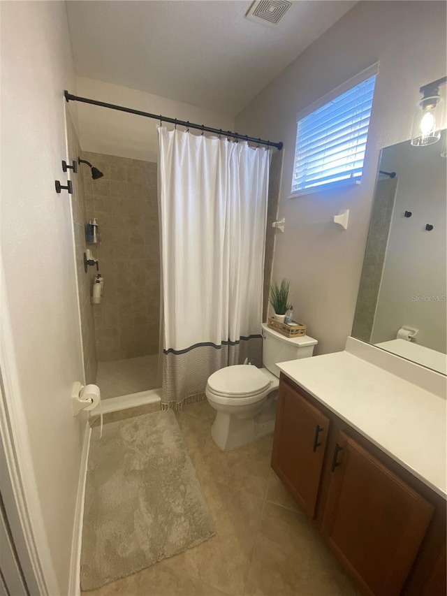 bathroom with toilet, tile patterned floors, a shower with curtain, and vanity