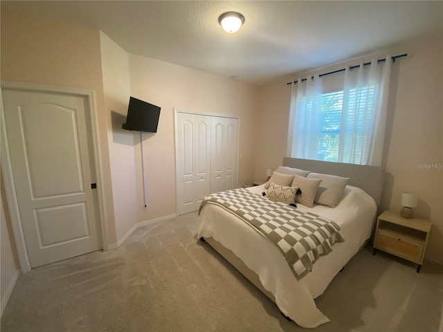 carpeted bedroom featuring a closet