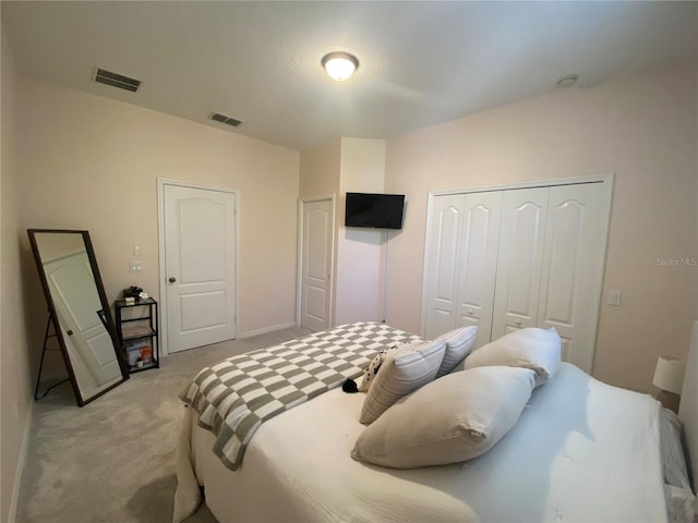 bedroom featuring a closet and light colored carpet