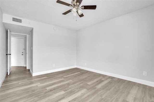 spare room featuring ceiling fan, a textured ceiling, and light wood-type flooring