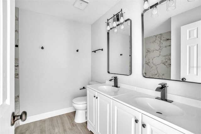 bathroom with vanity, hardwood / wood-style floors, and toilet