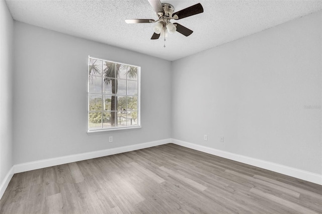 spare room featuring ceiling fan, a textured ceiling, and light wood-type flooring