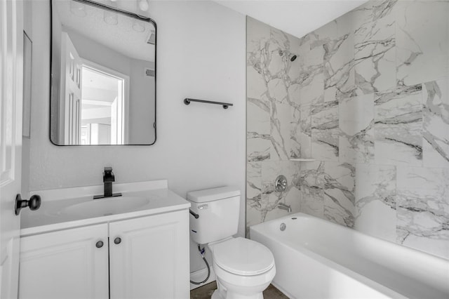 full bathroom with tiled shower / bath, vanity, and toilet