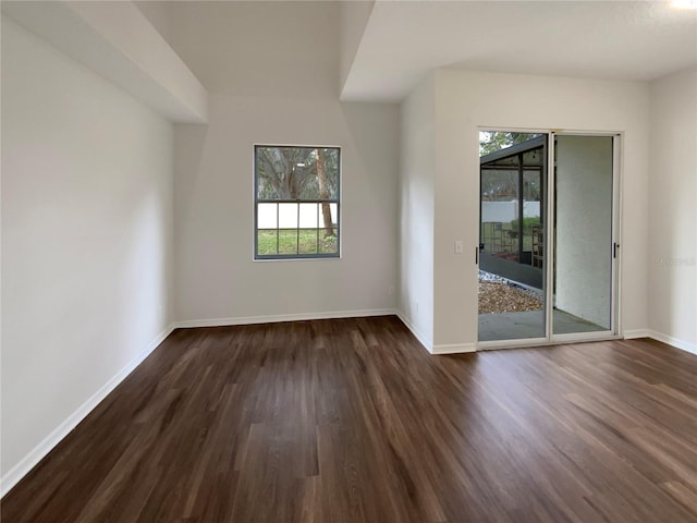 empty room with dark wood-type flooring