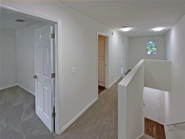 hallway with dark carpet